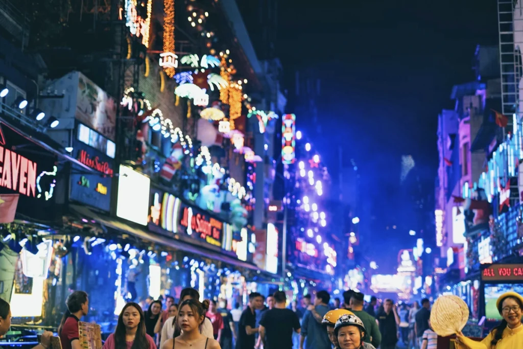 Hanoi vs Ho Chi Minh nightlife. Bright buildings at night in Ho Chi Minh City