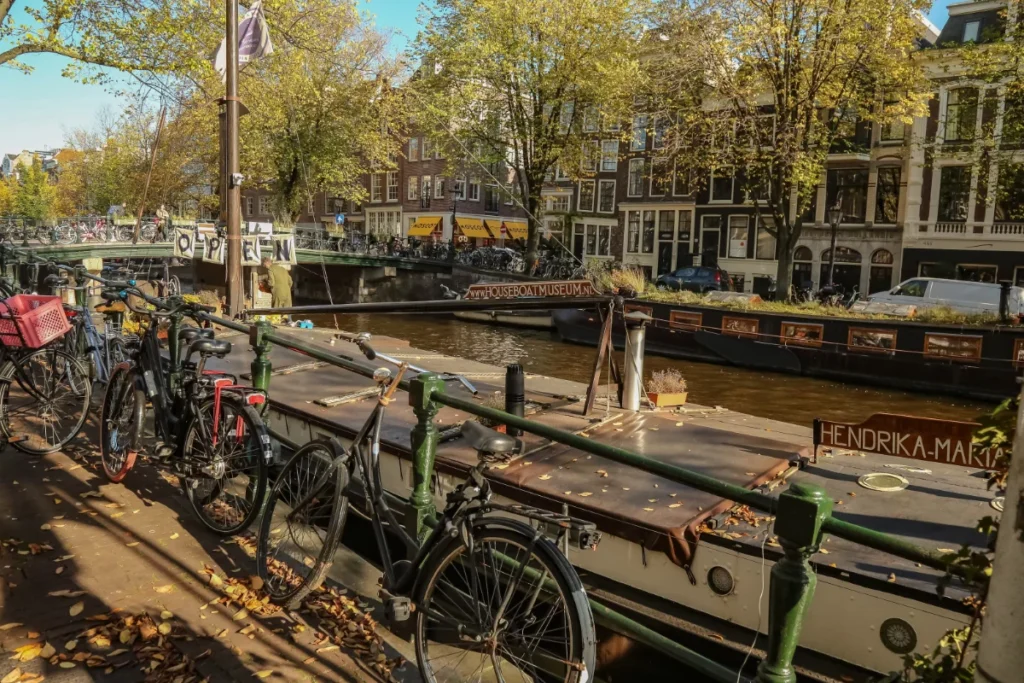 Street of Amsterdam and canal with bikes lining the streets. One of the best places to spend a week in Europe.